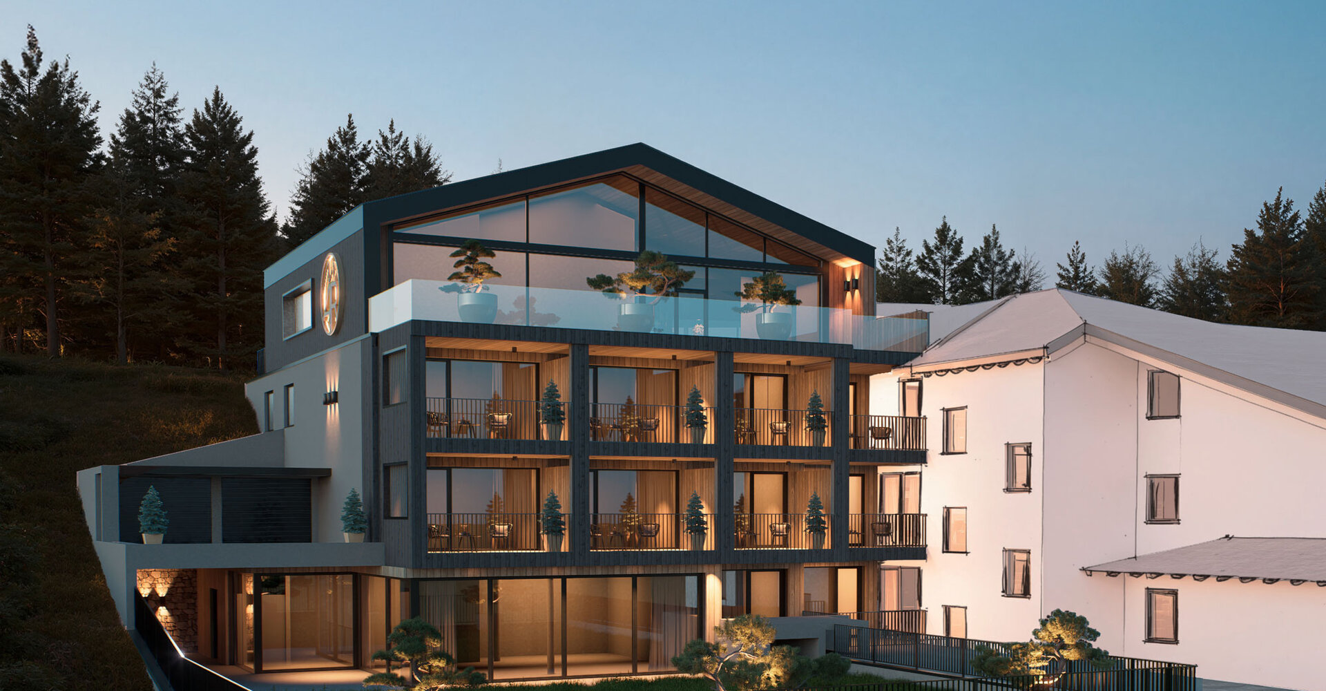 Modernes mehrstöckiges Gebäude mit großen Glasfenstern und Balkonen, abends warm beleuchtet. Angrenzend an ein weißes traditionelles Gebäude, umgeben von Bäumen, mit einem begrünten Vorgarten.
